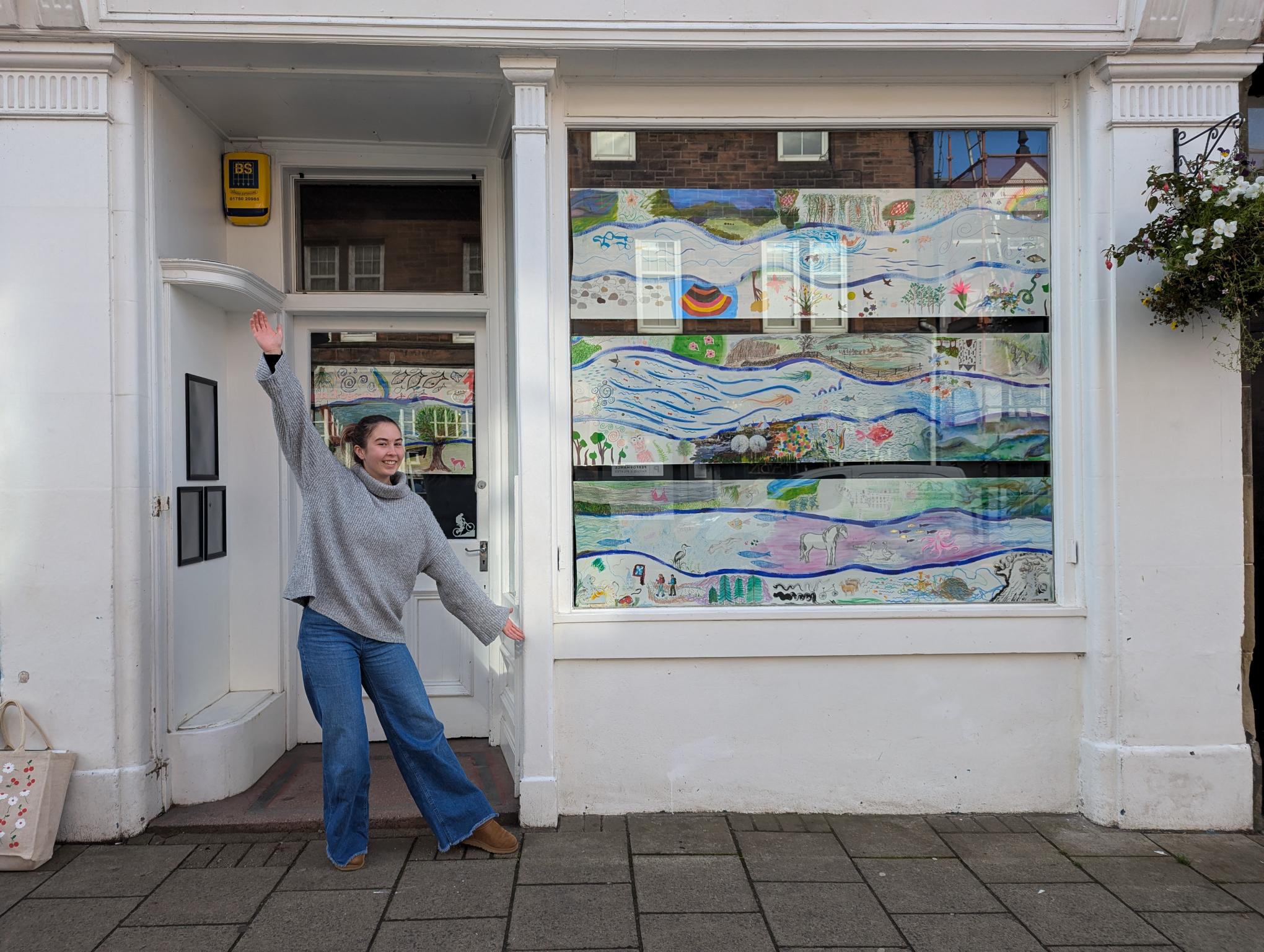 A window filled with a river-inspired communal artwork, the results of fundraising art-a-thon