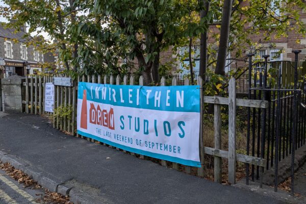 Open Studios banner attached to a fence